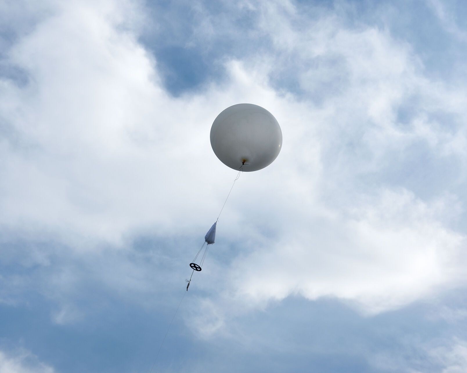 A weather balloon ascends into the sky